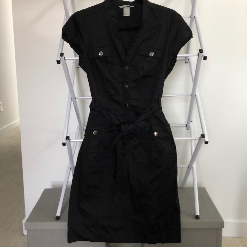 Black dress with silver snaps fits like a 6